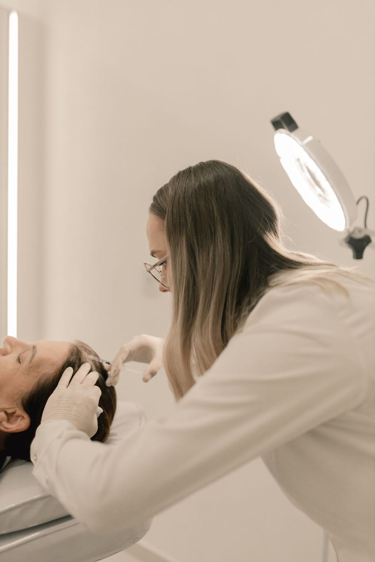 Dermatologist examining a skin lesion with a dermatoscope
