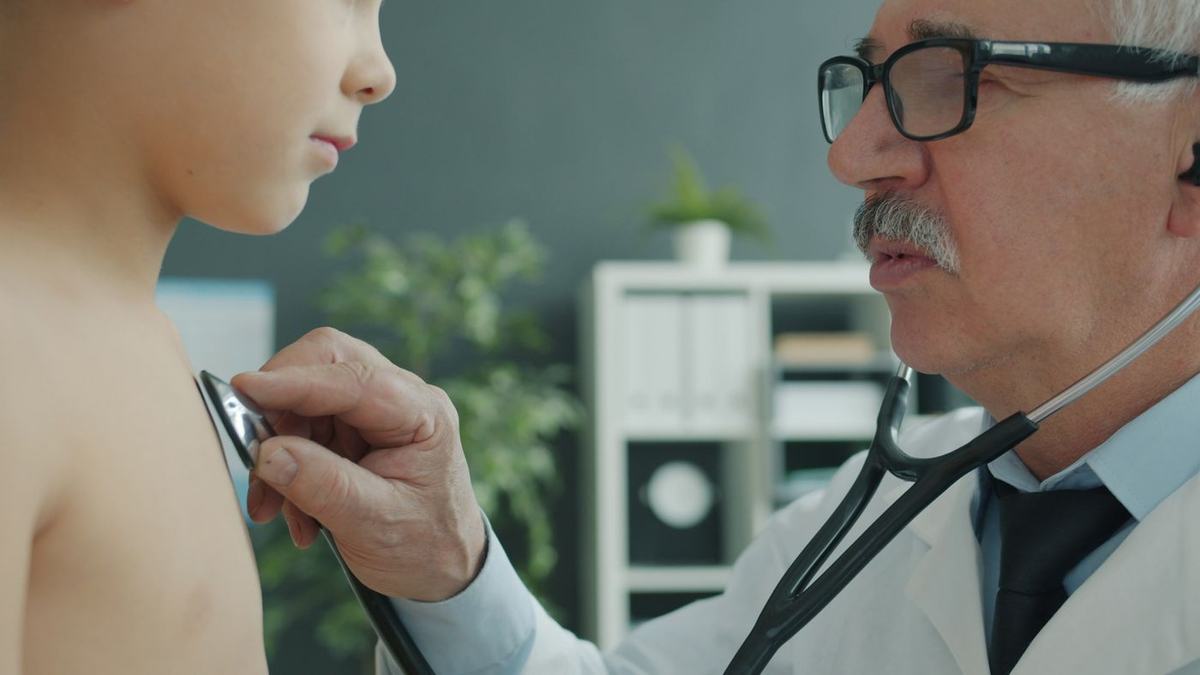 Dermatologist assessing a patient's arm